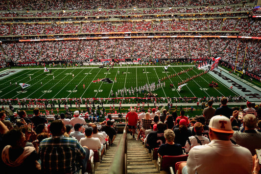 A wide shot of the Houston Texans on the field at the NRG Stadium. 