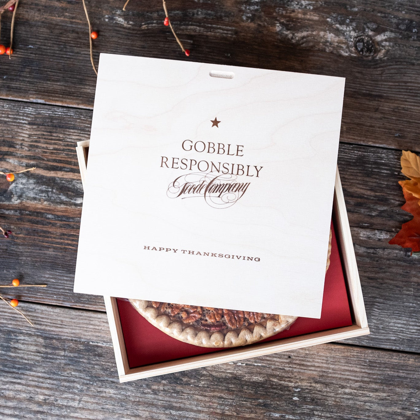 Wooden pecan pie gift box with "Gobble Responsibly" Thanksgiving message engraved on a wooden surface
